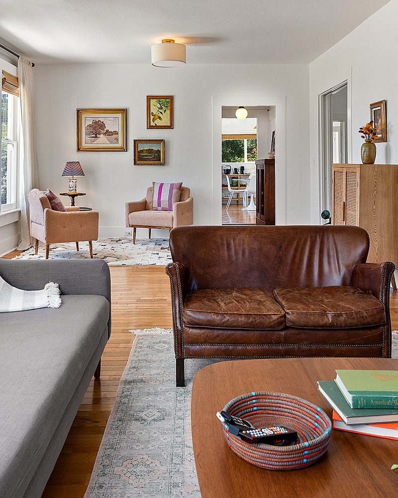Living room with a leather loveseat and walnut coffee table